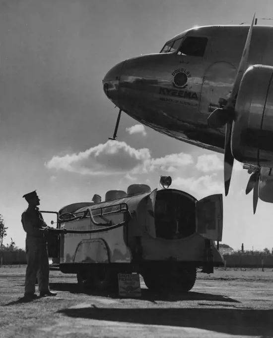 The giant Douglas DC2 airliner, "Kyeema," of Airlines of Australia, makes a striking early morning study as she refuels from the Shell refuelling Waggon at Mascot aerodrome. The machine is engaged on the Sydney-Brisbane service. August 15, 1937.