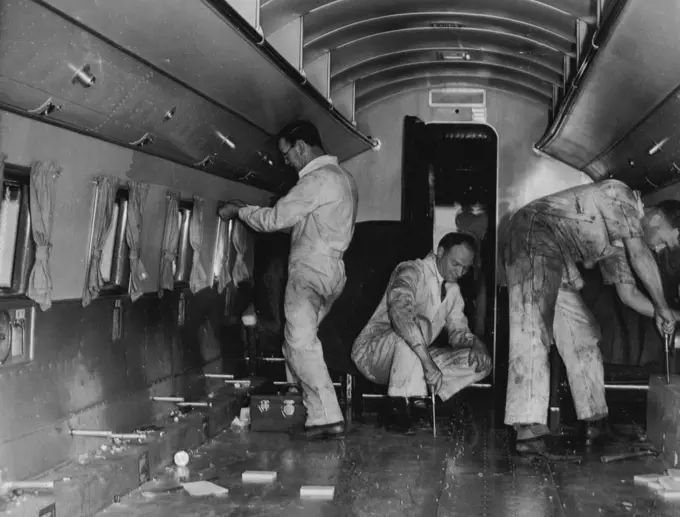 Four trips from Darwin to Calcutta and back before Christmas is the schedule of the big Douglas DC3 airliner, Kurana, which has been chartered from Australian national airways by imperial airways to help cope with the huge bulk of Christmas mails from overseas. Today's picture at Essendon is of the interior of the airliner stripped of its seats and other fitting in preparation for the mail transport. This year will mark the first occasion on which all first class Christmas mails from Great Brita