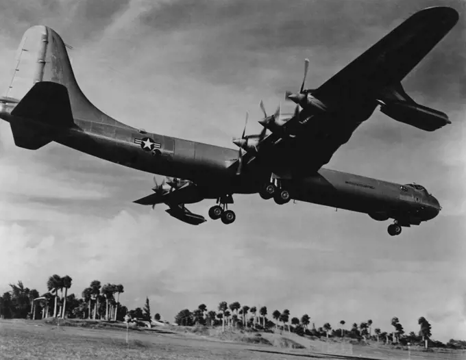 Supergiant of The Skies -- The World's first international bombers a 10 engine Convair B-36 - puts its two, huge, 4-wheel landing gears down for a landing at a tropical Air Force base. This supergiant of the skies has a wingspread of 230 feet-almost as long as a football field. Its length is 162 feet, and its height at the tail is nearly 47 feet or 5 stories high. With four J-47 jet engines nestled ***** its Six 3,500 horsepower reciprocating engines. This mighty Air Force bomber is capable of c