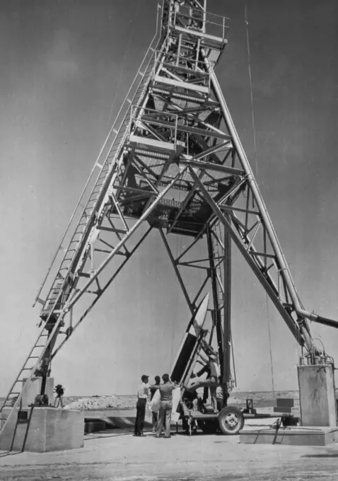 New Guided Missile Readied for Test -- A new Air Force guided missile, the NATIV built by North American Aviation, is lowered into position for a test firing on the Holloman Air Force base near Alamogordo, N.M. The missile is fired from a metal launching tower. January 14, 1949. (Photo by AP Wirephoto).