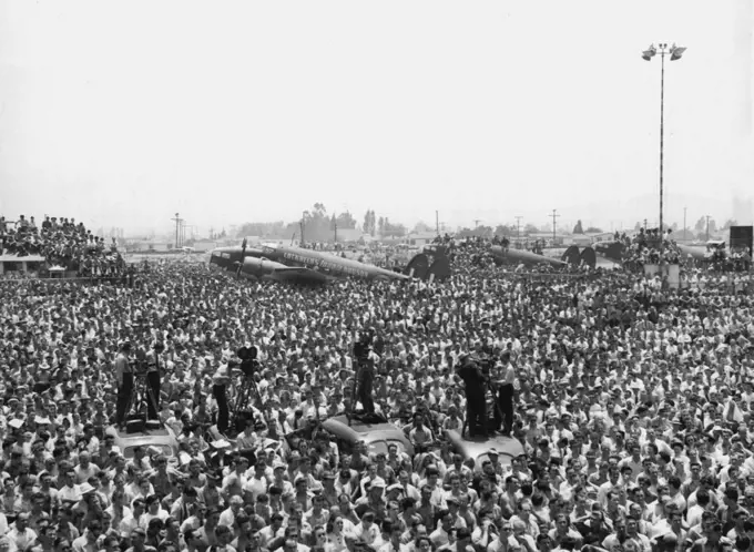 Lockheed Workers Hear Halifax -- Lockheed Aircraft ***** workers listen to Viscount Halifax, British ambassador to the United States, as he talked to them July 18 at Burbank, Calif.,on the completion of the 1000th Lockheed Hudson Bomber. This plane is used by the R.A.F. Coastal command. July 18, 1941. (Photo by Associated Press Photo).