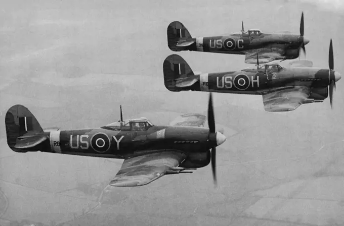 First Pictures of the Typhoon one of most Formidable Aircraft used by Fighter Command -- An aerial view of Typhoons flying in formation. These are the first pictures to be released of the Hawker "Typhoon" described as one of the most formidable aircraft in use in Fighter Command. Powered with the famous Napior engine the Typhoon is a single seater low-wing monoplane of metal construction. Its armament consists of cither four cannons or twelve machine guns. Already Squadrons equipped these fighte