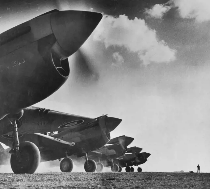 RAAF Kittyhawks rev up in preparation for another sortie over the Western Desert. They had successes against Italian and German air forces. December 7, 1942.