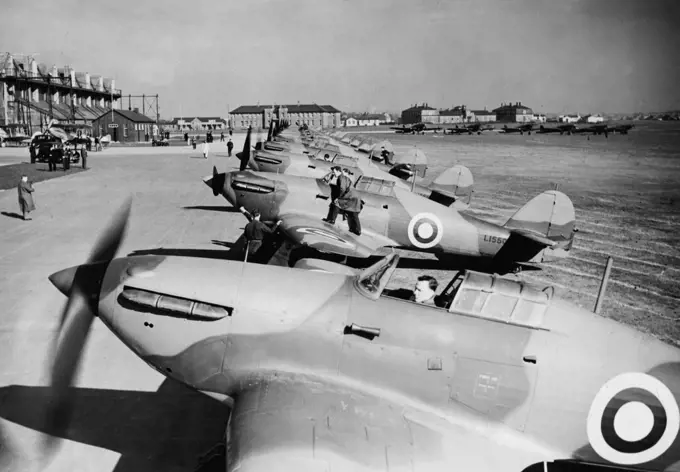 Demonstration Of Squadron Of Hawker "Hurricane" Fighters -- A line of the Squardon's Hawker "Hurricane" Fighters on the concrete at Northolt this afternoon. A demonstration of new Hawker "Hurricane" Fighter Air craft was given this afternoon by No.111 (F) Squadron at Northolt Aerodrome, Middlesex, Squadron-Leader Gillan recently flew one of these aircraft from Edinburgh to London at an average speed of 408 miles an hour. March 6, 1938. (Photo by Topical Press).