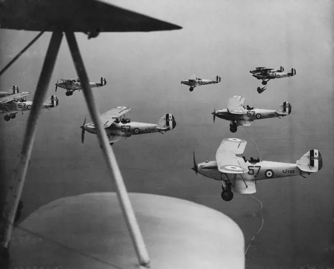 R.A.F. Practice ***** -- The 57th squadron rehearsing their diplay at Eyford  today. Planes of the 57th R.A.F. squadron rehearsed their display for the forthcoming R.A.F pageant which takes place at Hendon, at upper Heyford, Oxon, today May 29. May 29, 1934. (Photo by The Associated Press of Great Britain Ltd.).