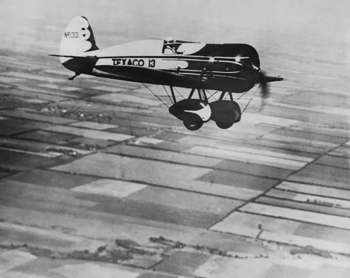 Doing The Bare 240 miles an hour - Capt. Hawks testing his machine for his attempt to shatter the record from New York to Los Angeles. August 19, 1930. (Photo by International News Photos Inc.).