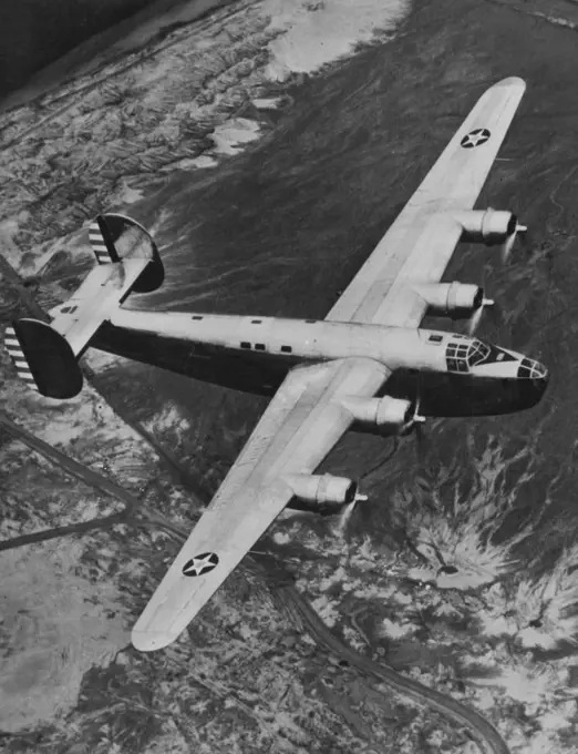 New Bomber Undergone Tests -- Consolidated aircraft Corporation's powerful new four-motored land bomber (above), designate as XB-24 by the army, is shown during a trial spin recently. The army, is shown during a trial spin recently. The ship which weighs 40,000 pounds and has a wing span of 110 feet, is driven by four 1200-H.P. Pratt & Whitney motors, capable of a speed of 300 M.P.H. for Approximately 3,000 miles. The bomb load is four tons. October 5, 1940. (Photo by ACME Photo).