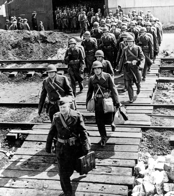 U.S. Marines Land in Ireland - Eager for Action: A contingent of U.S. Marines, wearing new type combat helmets and carrying field equipment, moves from a dockside shed after arriving in Northern Ireland to reinforce the ex-panding A.E.F. September 7, 1942. (Photo by Interphoto News Pictures, Inc.).