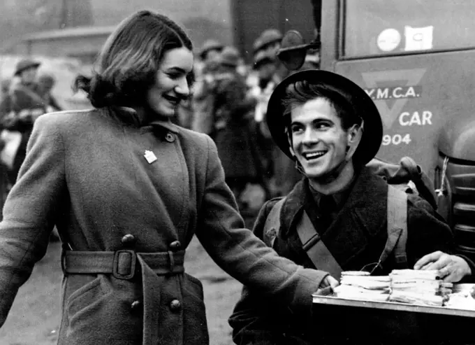 The "Y" Greets American Troops: An Irish colleen distributing free tea and sandwiches to the American troops on their arrival in Northern Ireland. April 16, 1942. (Photo by L.N.A.).