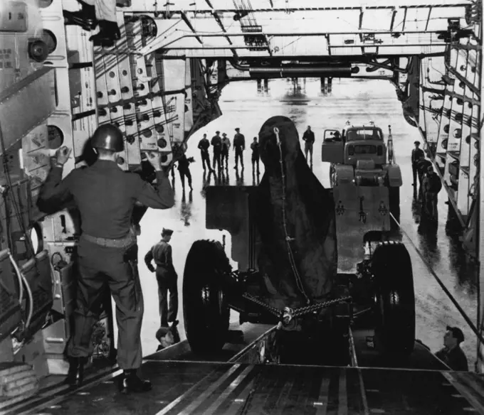 It's Spacious -- Giant Globemaster C-124 is loading 155 mm howitzer and tractor at McChord AFB today preparatory to flight to Los Angeles in an armed forces demonstration. The big plane carried 48,000 pounds, 32 personnel. October 13, 1950. (Photo by AP Wirephoto).