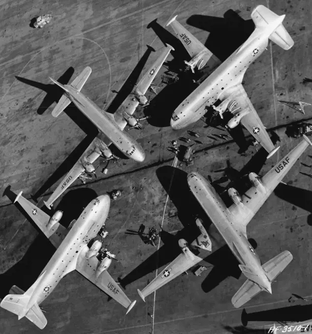 A Quartet Of Winged Giants Four huge U. S. Air Force 0124 Globemasters of the 374th Troop Carrier Wing (Combat Cargo) huddle on the flight line, between Combat Cargo missions on the Korean airlift. This unusual photograph of these three-story mammoths of the air was taken from a helicopter at the 374th base in Japan, while the C-124s of the 315th Air Division were receiving routine maintenance. They were parked this way to make maximum use of a central pool of tools and equipment. The four gia