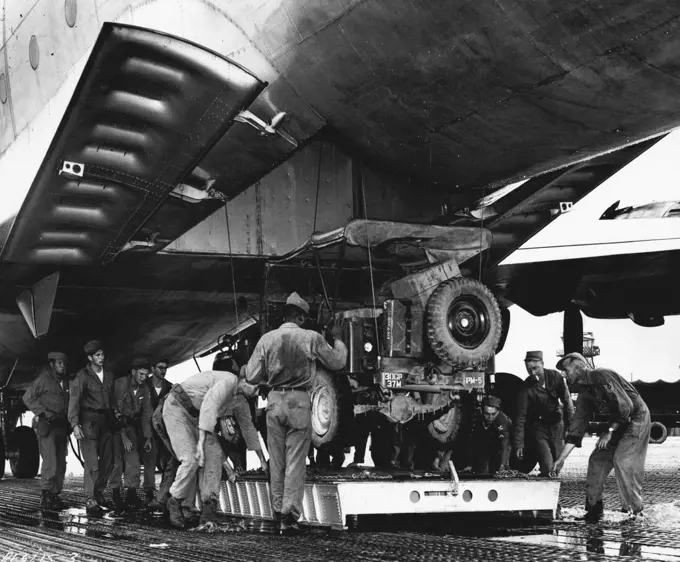 United States Mercy Mission To East Pakistan Loaded In Korea U. S. Air Force end Army personnel load a jeep aboard one of eight C-124 Globemasters which left recently with United States aid to flood-stricken East Pakistan. In the joint Air Force-Army mission, 40 members of the Army's 37th Medical Preventative Medicine Company and tons of medical supplies and equipment are being airlifted to the flood victims. The Globemaster crews include extra pilots, who will alternate at the controls in order