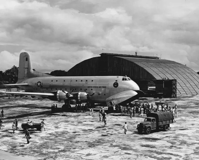 Cargo-Carrying U. S. Air Force C-124 Is Unloaded In Flood-Stricken Dacca The second U. S. Air Force C-124 Globemaster to arrive in the flood-stricken area of East Pakistan, is unloaded at the airfield in Dacca. Eight C-124s of FEAF's 315th Air Division are airlifting personnel of the U. S. Army 37th Radical Preventive Medicine Company and tons of medical supplies and equipment to the flood- ravaged area of East Pakistan. The crews of the aircraft include extra pilots,who are alternating at the c