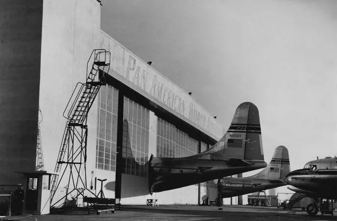 Even The Big hangars at San Francisco are too small for the new giant Pan-American Strato Clippers. To solve the problem, special holes were made made in the doorways. This picture was secured by a Sun photographer who has just returned from US. March 15, 1951.