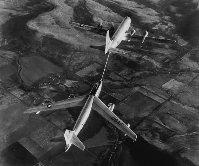 Fastest Jet Bomber Tanked Up In Air -- Here's the first released picture of the world's fastest bombers, a six-jet, 600-mile an-hour Boeing B-47 stratojet bomber, (bottom) being refueled from a double-deck Boeing KC-97A tanker plane. In this method of refueling, now a standard U.S. Air Force practice, fuel boom form under tail of tanker plane is connected with coupling in nose of bomber and the fuel is pumped in at high speed. June 18, 1951. (Photo by AP Wirephoto).