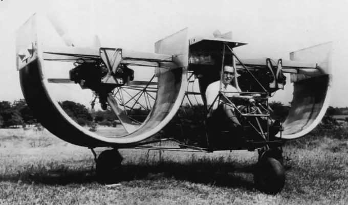 'Channel Wing' Plane -- Frank D. Kelley, Hagerstown, Md., commercial photographer and President of National Aircraft Corporation, sits at the controls of an unusual aircraft with "Custer Channel Wings", which resemble halves of Barrels. Kelley has flown the craft on several brief flights according to the inventor of the strange machine, Willard R. Custer. Photo, made 10 days ago, released by Kelley in Hagerstown, July 3. July 03, 1948. (Photo by AP Wirephoto).