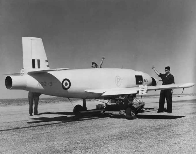 A ground crew gives the "thumbs up (she's ready)" sign to ***** a Jindivik pilotless, jet, radio-controlled target aircraft ***** for launching. Mr. Menzies then launched the plane by pressing button two miles away. May 01, 1953.