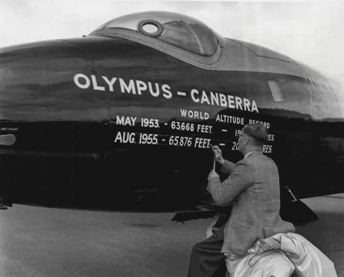 1955 Farnborough Air Show -- A sign-writer at work recording on the fuselage of the aircraft the fact that this Canberra aircraft has just established a new world height record. September 05, 1955. (Photo by Daily Express Picture).