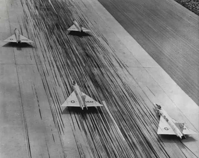 Illusion of Speed - These four Convair F-102A all-weather jet interceptors seem to be racing down runway at Palmdale, Calif. The planes are standing still but the illusion of speed comes from the delta wing interceptors streamlining and from the hundreds of tire streaks left on the concrete runway by landing aircraft. October 04, 1955. (Photo by AP Wirephoto).