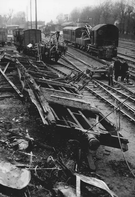 Remains Of Wrecked Coach After Rail Crash - The floor of a coach, barely recognisable, in which most of the 12 people who died lost their lives in a train accident just outside Barnes station London, at 11.28 last night. The wreckage, quickly being cleared to reopen the lines today (Saturday) is all that was left of the coach, which caught fire when an electric train from Waterloo to Windsor struck the rear of a goods train travelling from Battersea Yard to Brent. One hundred and fifty passenger