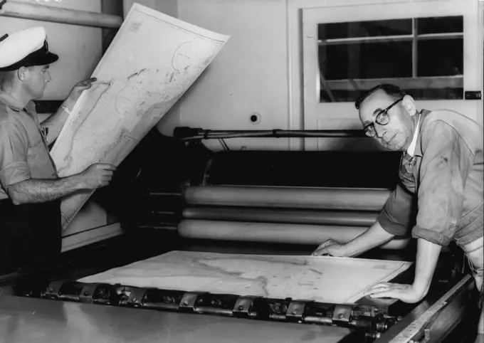 First Exmouth Gulf Charts -- The Ran Hydrographic printing office as garden is at present producing the first exmouth gulf charts to be available to the public. They will be issued as from Monday next. On right is Mr. J. H. Tepper, Lithographic printer who is printing the charts and left is petty officer W.R.Wallace, A Survey recorder who took part in the survey carried out by HMAS Barcoo. September 15, 1955. (Photo by Ronald Leslie Stewart/Fairfax Media).