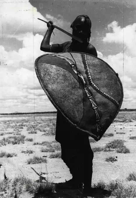 A proud warrior from the nomadic Masai tribe dressed in his traditional red robe and carrying his ancient weapons. Proud Masai warrior poses with spear and cowhide shield. June 20, 1955. (Photo by Toni Schuler, PIX Incorporated). ;A proud warrior from the nomadic Masai tribe dressed in his traditional red robe and carrying his ancient weapons. Proud Masai warrior poses with spear and cowhide shield.