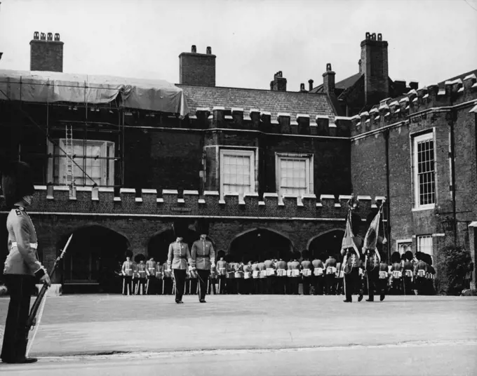 Changing of the Guard Now at St. James's Palace So As Not To Disturb The King - The Grenadier guards are being relieved by the Scots guards during today's changing of the guard at St. James's Palace. Today's changing of the guard ceremony took place at St. James's Palace instead of at buckingham palace, so as to avoid disturbing the king during his recuperation from his recent operation at Buckingham palace. September 23, 1951. (Photo by Paul Popper Ltd. ). ;Changing of the Guard No