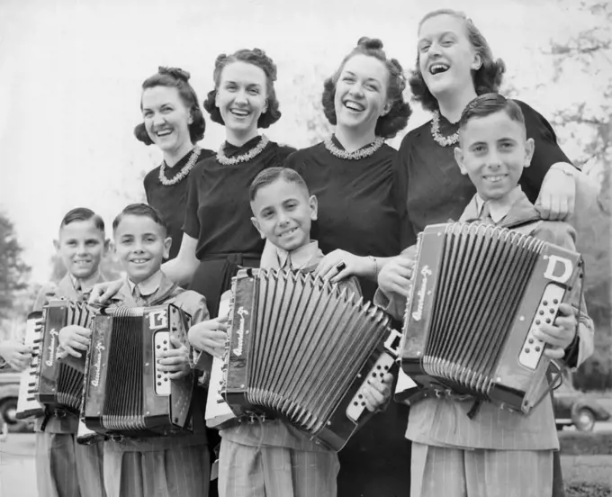 When Quads Meet Quads - Swing music by two sets of Texas Quadruplets was a feature at the twins convention in Waco, Tex., March 24. The Perricone's (l to r) Anthony, Bernard, Carl and Donald swung their accordions for a vocal rendition by the key sisters, (left to right), Roberta, Mona, Mary and Leota. March 25, 1939. (Photo by Associated Press Photo).