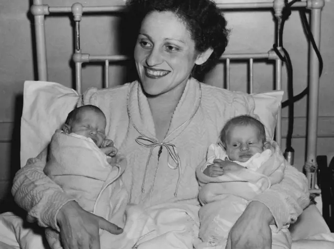 Forty Nappies A Day - Dark-eyed Mrs. Gita Wiernik (above) received the surprise of her life in triplicate.Until her triplet daughter were born, she expected twins."I did not want to frighten her, so I told her to expect twins when to expect twins when the doctor broke the news to me a few months ago," said Mr. Wiernik."I asked all the nurses and doctors at the hospital to keep the secret, and until they arrived, my wife was still expecting twins." October 27, 1955.