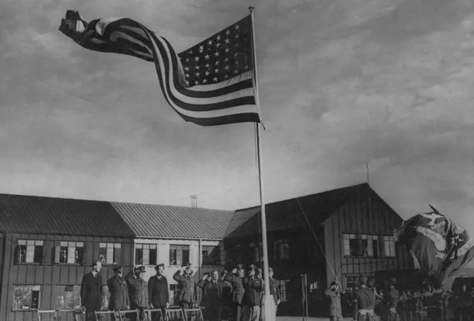 Transfer Ceremony of The 8th U.S. Air Force -- Raising the "Stars and Stripes" during the ceremony.One of the many repair depots in the United Kingdom was formally transferred to the United States VIII Air Force Service Command "Somewhere in the North of England". This station which has been under the control of the Ministry of Aircraft by Air Vice-Marshal Weedon, and was accepted by Major General Henry J.F. Miller, of Miami, Florida, commanding general of the VIII Air Force service command. Oct