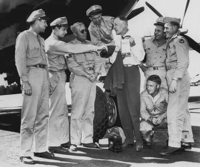 Crew After Record Flight -- Crew members of an army B-29 look over their sealed flight instruments after racing from New York to Burbank today in seven hours, 28 minutes, establishing Larry Therkelsen, official N.A.A. Timer. The fliers, left to right: Capt. B.L. Grubaugh, pilot