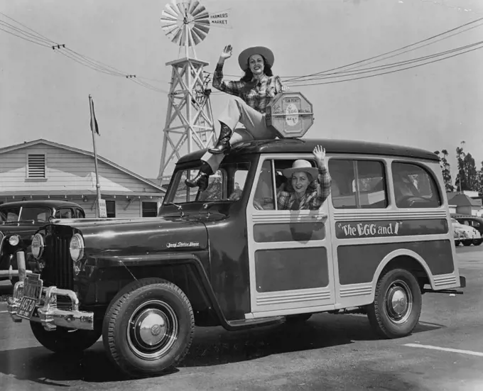 Movie starlets Judith Woodbury and Joan McTavish are pictured as they left Los Angeles' famed Farmer's Market enroute to New York City with a print of "The Egg and I." The girl featured in the movie version of the Betty MacDonald best­seller, also delivered a basket of fruit and a dozen eggs to New York's Mayor O'Dwyer--compliments of Claudette Colbert and Fred MacMurray, co-stars of "The Egg and I." February 09, 1948.