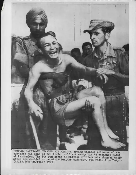 He Changed His Mind -- A crying Chinese prisoner of war clutches his cane as two Indian soldiers carry him to exchange point at Panmunjom. The POW was among 65 Chinese soldiers who changed their minds and decided on repatriation. September 27, 1953. (Photo by AP Wirephoto).