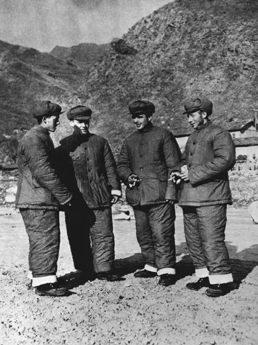 British Prisoners of War In North Korea -- Four British prisoners of war who were captured in November 1951 by the Chinese people's volunteers. Picture shows the POWs are wearing their new issue of cotton-padded winter clothes supplied by the Chinese people's volunteers. From left to right; Eric Wragg (22426986), "B" Co., 1st Royal Leicester 29th Brig. Address: 34 Outram Road, Wyboorm Estate, Sheffield 2, England: William Walker (22391663), "B" Co., 1st King's Own Scottish Borders. Address: 23 Keyden Street, Kinning Park, Glasgow, Scotland; George Marshall (22436971) 1st Brn., Royal Leicester Regt. Address: 10 Butter Road, Bilton, Harrogate, Yorkshire, England, and David Whittaker (22431499) "B" Co., 1st Bn., Royal Leicester Regt. Address 29 Cherdle Street, Burnley, Lancashire, England. July 11, 1952. (Photo by Camera Press).