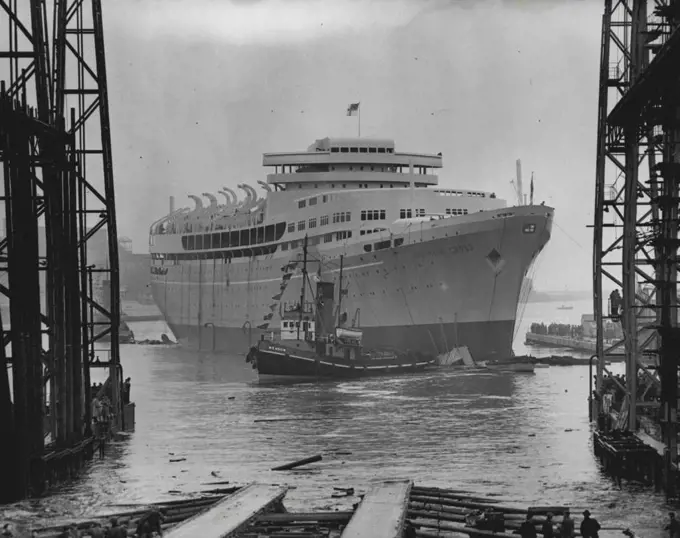 Southern Cross Afloat - Proudly riding the water after her launching by the Queen today (Tuesday) is the new Shaw Savill luxury liner the Southern Cross, built at the Belfast yard of Harland and Wolff. The ship, of 20,000-tons, has funnel and engines is stalled aft like an oil tanker and is intended for service between Britain and Australia and New Zealand. She cost more than seven million pounds and will not carry any cargo. August 17, 1954. 