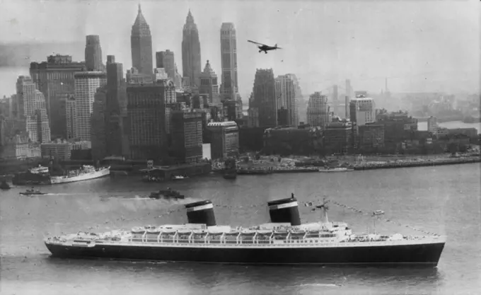 Super Liner Sails On Maiden Voyage -- The United States, America's newest and largest passenger liner, moves past lower Manhattan sailing outbound today on her maiden voyage to Southampton and LeHavre. The new liner carried 1,660 passengers, including Margaret Truman, daughter of the president. July 3, 1952. (Photo by AP Wirephoto).