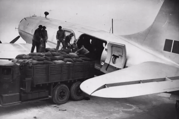 Britain's Latest Planes To Boost Berlin "Air Lift" -- German workmen loading coal into one of the new "Hastings" aircraft at the base near Kiel, in readiness for the flight to Berlin. Eight Handley Page "Hastings" Britain's latest, now being used to increase the R.A.F.'s share in the great Berlin "air lift". Each aircraft is capable of carrying seven and a half tons and will be used mainly for transporting coal. The squadron will work from a specially prepared airfield about 25 miles outside Kiel. November 03, 1948. (Photo by Sport & General Press Agency, Limited).