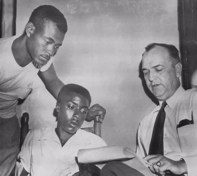 State Witnesses With D.A. -- District Attorney Gerald Chatham (right) talks with state witnesses Walter Billingsley (left) and Willie Reed (center) before court session today in which two men are charged with the murder of Emmett Till. While on the witness stand today Reed told the court he saw J. W. Milam, one of the defendants, at a plantation barn in Sunflower Count on the morning after Till was abducted. September 22, 1955. (Photo by AP Wirephoto).