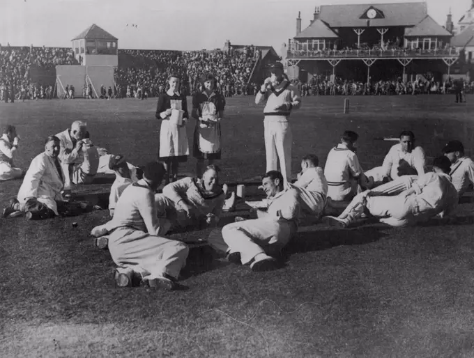 The 1945 Australian Services team discusses legends of the Scarborough wicket as they have afternoon tea. August 17, 1948.