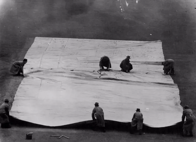 Covering the Wicket at the Melbourne Cricket Ground when ***** stopped play in the shefflied Shield match between Vic & NSW. January 04, 1949.