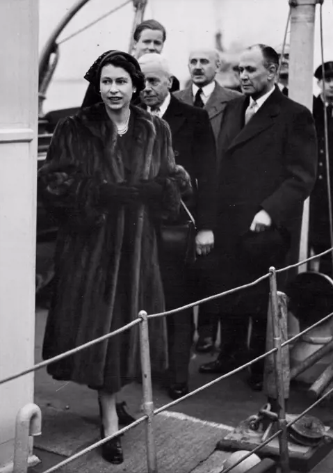 H.M. The Queen Visits The Flood Areas of Kent And Essex. The Queen coming ashore at Gravesend where she put on a fur coat to continue her tour. This afternoon H.M. the Queen paid a visit to the flood areas of Kent and Essex, accompanied by the Lord Lieutenant of Essex Sir Francis Whitmore. Apart, from three factories in Purfleet which were flooded, the Queen also visited some of the flooded homes in Purfleet, Tilbury and Gravesend. February 13, 1953. (Photo by Fox Photos).