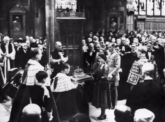 The Queen's Visit to Scotland. During the Queen's Royal visit to Scotland, she attended a national service of thanksgiving and dedication in St.Giles's Cathedral, Edinburgh, today. Picture shows a scene inside the Cathedral - the Queen returns the crown of the Scottish Crown Jewels to the care of the Duke of Hamilton. Prince Philip, in Field-marshal's uniform, stands behind the Queen on her right. June 24, 1953. (Photo by Evening Standard).