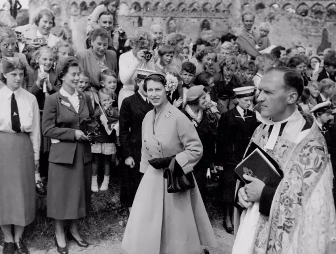 The Queen leaving St. David's cathedral wearing a hat trimmed with hydrangea. The brooch is a Scots thistle. August 7, 1955. (Photo by Daily Express). 