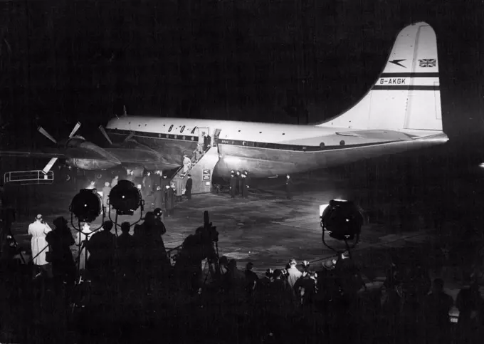 Royal Couple Off To Canada -- The Floodlights playing on the huge Canopus. In their glare the Queen, Followed by Princess Margaret, is seen walking down the Gangway. The goodbyes have been said. and a few minutes after this picture was taken the Royal Plane Took off. Scenes at London Airport last night when Princess Elizabeth and the Duke of Edinburgh were boarding the Strato-Cruiser Canopus for their 3,400-mile flight to Canada. October 08, 1951. (Photo by Paul Popper).