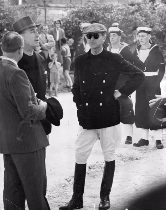 Polo headgear... Maltese style For the Duke of Edinburgh, a cloth cap (very comfortable fitting). The game was a fine afternoon out for the royal children, who watched Daddy play minus cloth cap. Duke of Edinburgh wearing a Maltese style cloth cap for his game of polo at Malta. The Royal children watched the game and saw their father drop his informal headgear as he went into action. May 10, 1954. (Photo by Daily Mirror). 