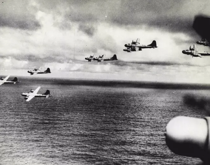 B-29'S Rehearse For Attack On Tokyo In formation, a group of B-29 Superfortresses flies over the sea near Saipan in the central Pacific Marianas, where a new base has been built for the American "sky battleships"; This was one of a series of practice flights the giant bombers made before their first attack on Tokyo on Nov. 23, 1944. After this smash at industrial targets of Japan's capital, General H. H. Arnold, commander of the U.S. Army Air Forces and commanding general of the global 20th (Superfortress) U.S. Air Force sent this congratulatory message to Brigadier General Haywood S. Hansell, commanding general of the Saipan-Based 21st BomBer Command! "You have successfully engaged the enemy in the very heart of his empire. This marks the Beginning of what I know will be a most distinguished career for the 21st Bomber Command..." December 22, 1944. (Photo by U.S. Office of War Information).