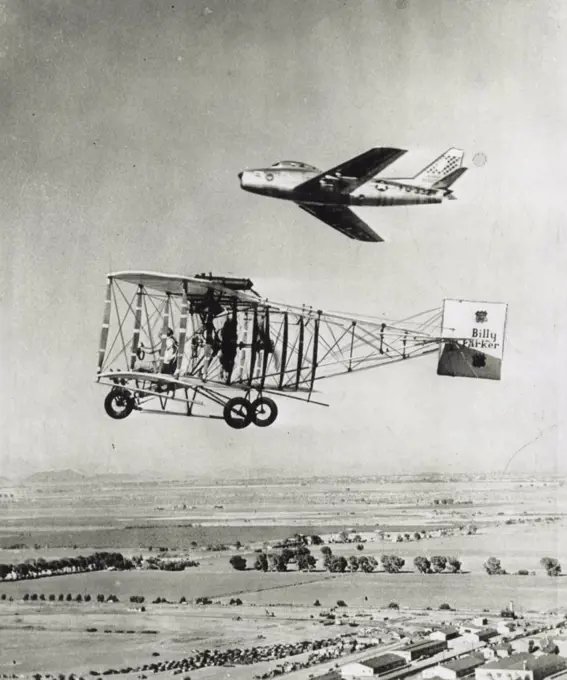 40 Years Of Progress -- What has happened to the airplane in four decades is graphically revealed hare of a an Air Force North American F-86 Sabre jet flying by a 1912 model pusher biplane. The Sabre holds the official speed record of 670 miles per hour and is powered with a turbo jet engine with a horsepower rating of 9,000 as compared to 80 horsepower and a cruising speed of 60 miles an hour for the biplane built and flown by Billy Parker. February 29, 1952. (Photo by AP Wirephoto).