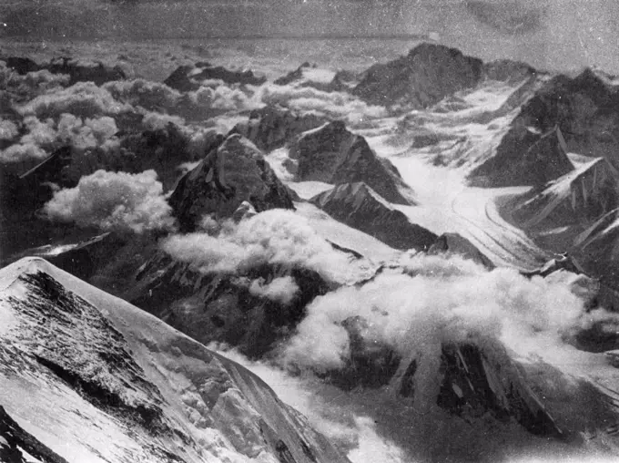 The Highest Point in the World at which Photographers have ever been taken (The Mount Everest Expedition: "The Times" Service) A panorama of the other mountains of the Everest group taken by Mr. Somervell from the same point on Mount Everest as picture No 73 - at a height of 28,000 feet above sea level. About the view from his point Mr. Somerwell wrote: "Around we saw a perfect sea of fine peaks, all giants among mountains, all as dwarfs below us. The view, indeed, was indescribable, and one simply seemed to be above everything in the world." August 22, 1924.