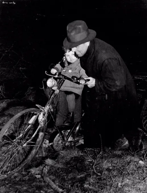 The horrors suffered by refugee victims of Hitler's lust for power now are being suffered by the German people. Here is a German pushing his little boy through the mud of a battle field to the safety of Canadian lines. April 30, 1945. (Photo by Canadian Wartime Information Board).