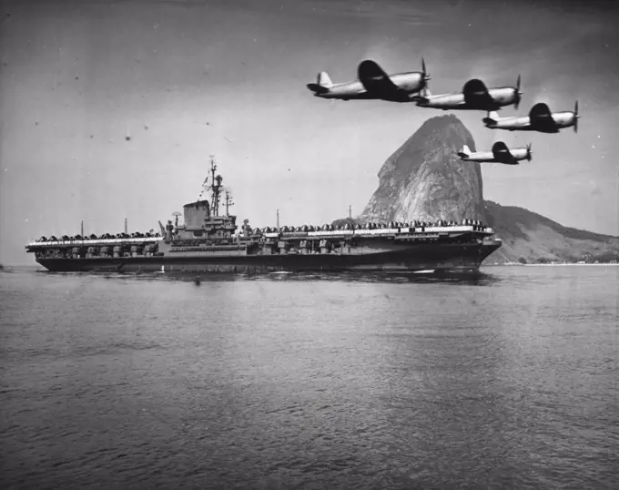 F.D.R In Rio De Janerio - The mighty aircraft carrier, Franklin D. Roosevelt, the largest naval ship afloat, is shown as she arrived here for a ten day visit. Escorted by Brazilian aircraft, the carrier steamed into the harbour with her flight deck completely covered with planes. Prior to her arrival here, the F.D.R. had been on shakedown. Sugar loaf mountain can be seen in the background. September 2, 1946. (Photo by Wide World Photos).